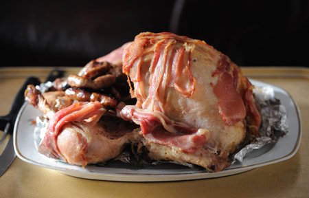 Tender bacon wrapped roasted turkey, with stuffing, being servedの写真素材