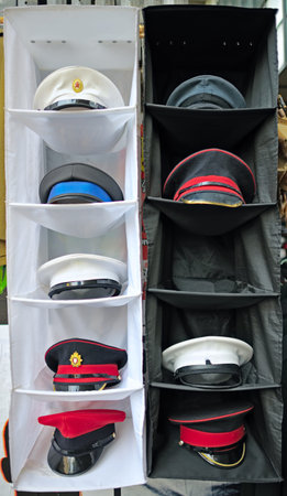Peaked / forage / combination style military caps in a street market displayの写真素材