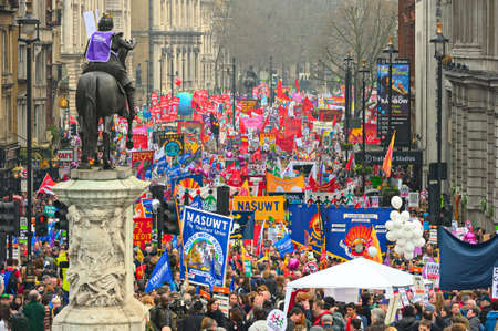 LONDON - MARCH 26: Protesters march down Whitehall against public expenditure cuts in a rally -- March for the Alternative -- organised by the Trades Union Congress (TUC), London, England,  March 26 2011のeditorial素材