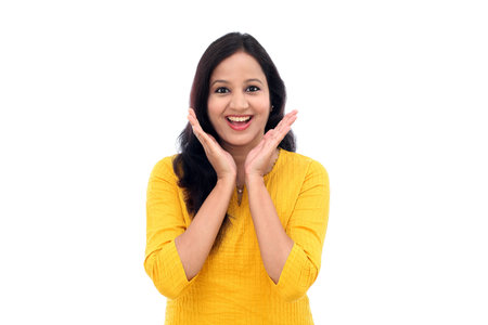 Excited young indian woman against white background