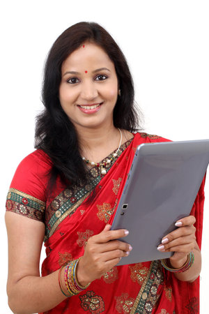Traditional Indian woman using a tablet computer