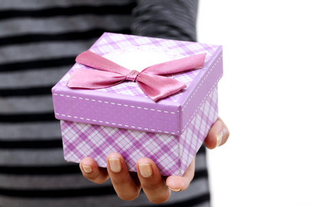 Female hands holding small gift boxの写真素材