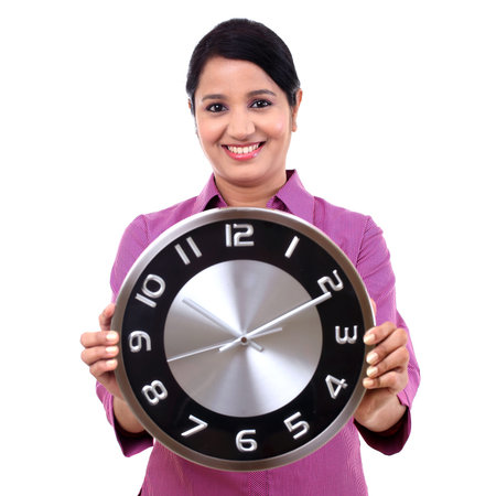 Young business woman holding clock in hands