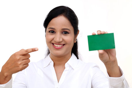 Smiling business woman showing blank business cardの写真素材