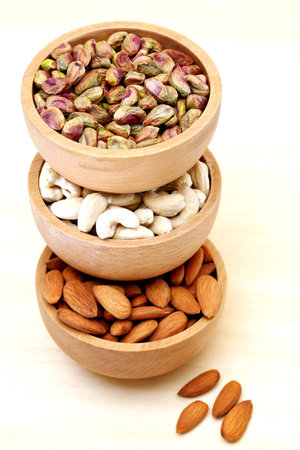 Almonds,cashew nuts, pistachio in a wooden bowlの写真素材