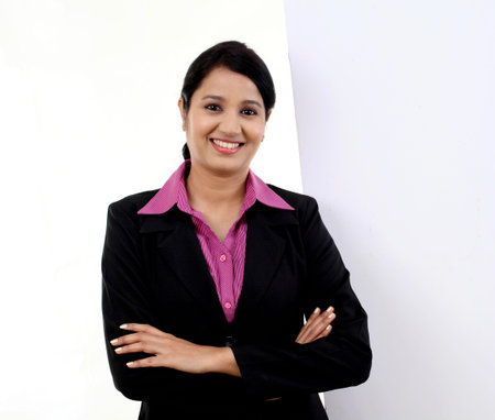 Happy business woman showing blank signboard against whiteの写真素材