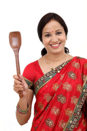 Traditional Indian woman holding wooden ladleの写真素材