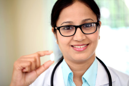Young female doctor holding up a pillの写真素材
