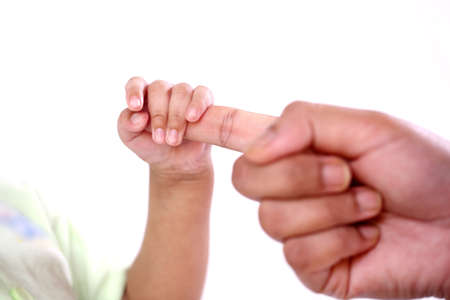 Newborn baby gripping mothers fingerの写真素材