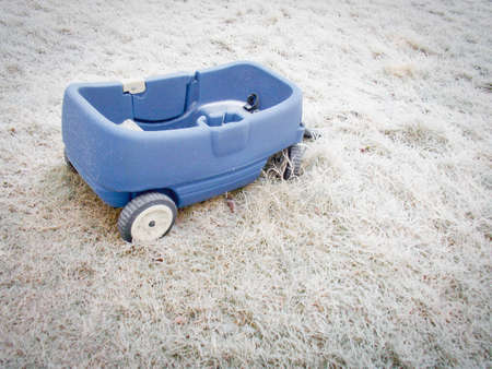 Blue wagon in Ice Covered Grass in Winterの写真素材