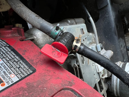 Close up of the engine compartment of a red car with a red key