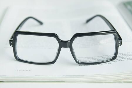Glasses on a bookの写真素材
