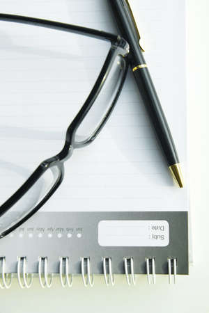 Glasses and pen on diaryの写真素材