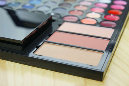Make up colorful palette on wood floorの写真素材