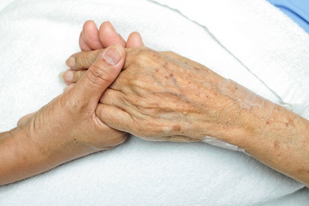 image of Woman ComfortingHand with her mother の写真素材