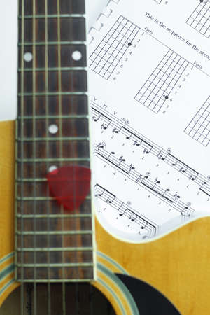 Acoustic Guitar on music note sheet ,focus at music note sheet.の写真素材