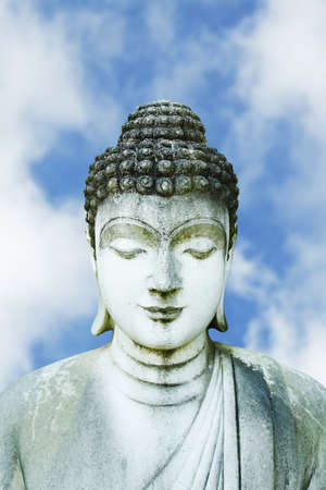 Stone Statue of Buddha with blue skyの写真素材