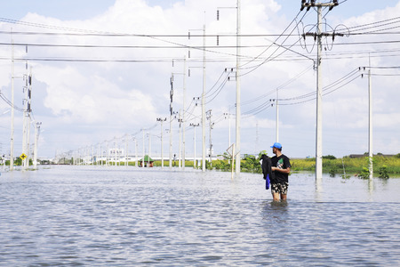 CHONBURI THAILAND - Oct 18,2013    Unidentified man walking in water  Water flooding attack to Amata Nakorn Industrial Estate in Chonburi Thailand のeditorial素材