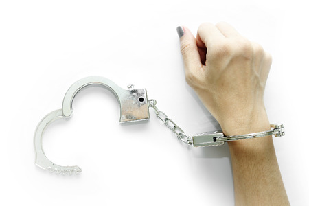 Right hand of Woman with handcuffs on white backgroundの写真素材