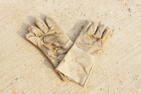 Pair of safety gloves on concrete floorの写真素材