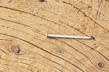 The closeup nail on wooden textured patternの写真素材