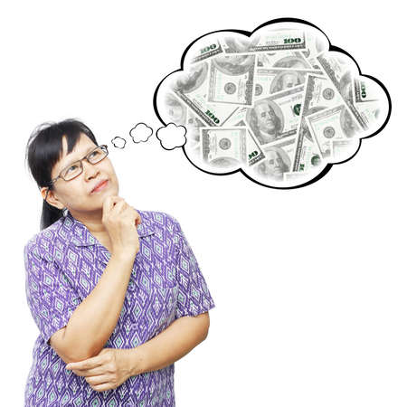 Thinking Asia woman looking up on thought bubble of money stackの写真素材