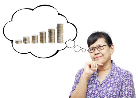 Thinking Asia woman looking up on thought bubble of columns coinの写真素材