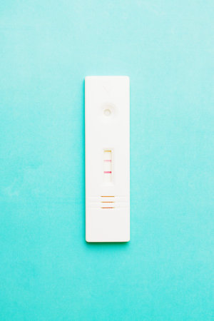 photo of Positive pregnancy test on green background.の写真素材