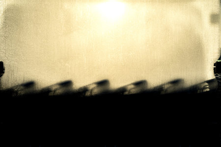 On a cold day the glass of a shopping cart housing is frosted and the sun casts an abstract shadow...