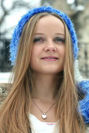 Blond freckled girl with blue hatの写真素材