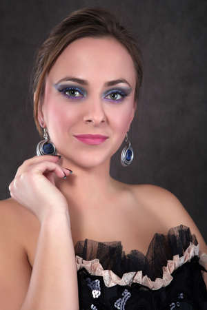 Beautiful blond girl with jewelry looking into the cameraの写真素材