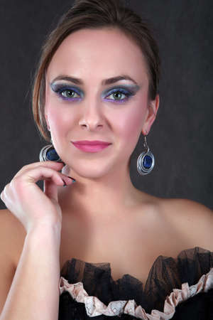 Beautiful blond girl with jewelry looking into the cameraの写真素材