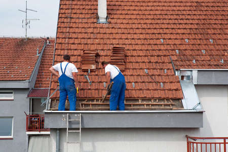 Two men working on the roofの写真素材