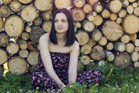 Woman in front of logsの写真素材