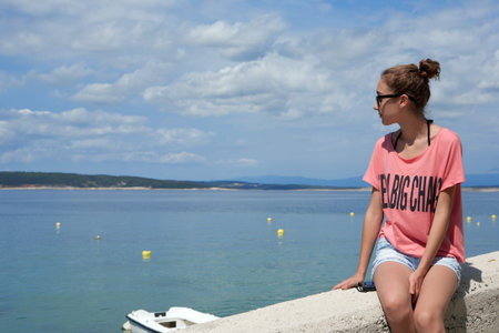 Teenage girl looking at the sea