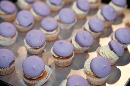 Cakes with yellow cream and purple topの写真素材