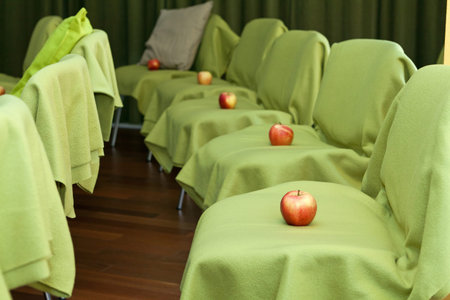 Apples placed on the chairs for each member of the auditoriumの写真素材