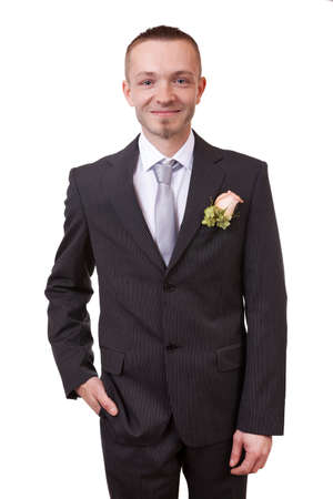 Groom holding hand in his pocket, isolated in whiteの写真素材