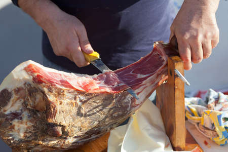 Man slicing famous Dalmatian prosciuttoの写真素材