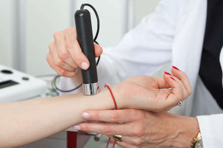 Dermatologist examining birthmarks and moles on a female patient (examination of birthmarks)の写真素材