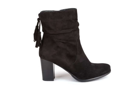 Black ankle boot with a tassel isolated on white (with shadow)の写真素材