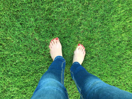 Barefoot selfie on the grassの写真素材