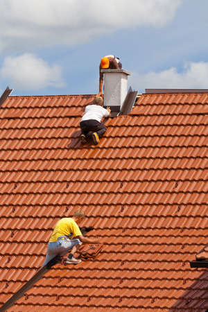 Men working on the roof of a buildingの写真素材