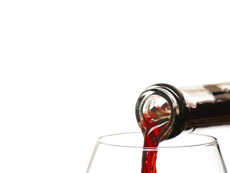 red wine being poured into glasの写真素材