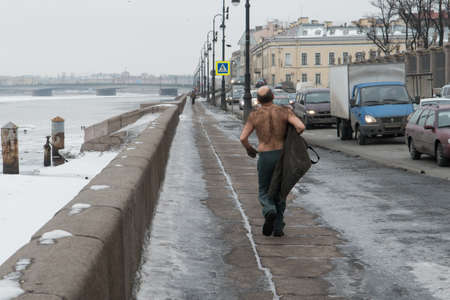 St. Petersburg, Russia - February 15, 2013: a man with a bare-chested in the winter makes the sport jogging along the embankment of the river Neva.のeditorial素材