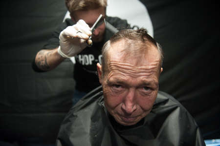 St. Petersburg, Russia - December 4, 2015: Australian barber Naser  Sabhani with friends have made hairstyles for homeless people on city streetのeditorial素材