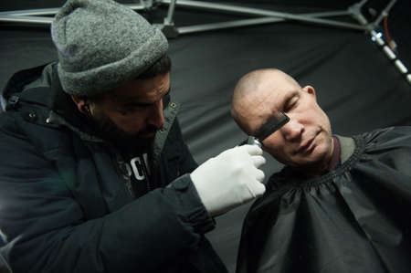 St. Petersburg, Russia - December 4, 2015: Australian barber Naser  Sabhani with friends have made hairstyles for homeless people on city streetのeditorial素材