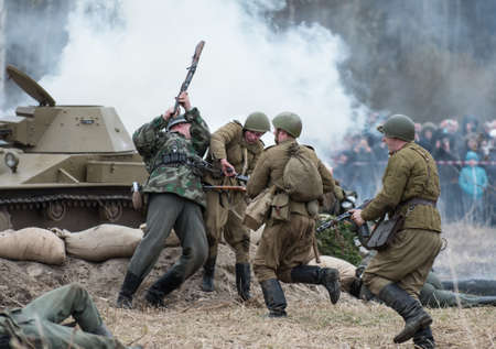 St. Petersburg, Russia - April 26, 2015: Members of the military-patriotic club during the historical reconstruction of World War II battle for the Seelow Heights, Dogfight Russian and German soldiersのeditorial素材