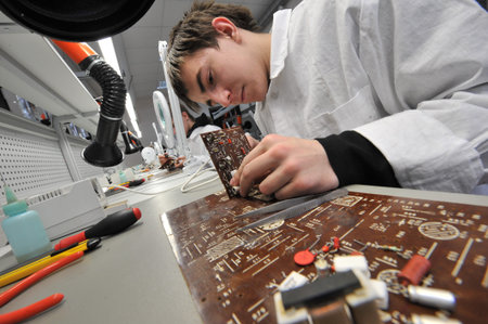 St. Petersburg, Russia - March 18, 2015: Students of vocational school in a workshop  of electrical...