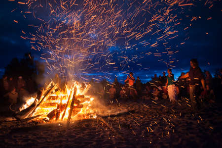 Leningrad Oblast, Russia - July 14, 2015: Big  tourist bonfire on the beach Finland Gulf during the festival. Young people dance and sing around the campfire. Deep night.のeditorial素材